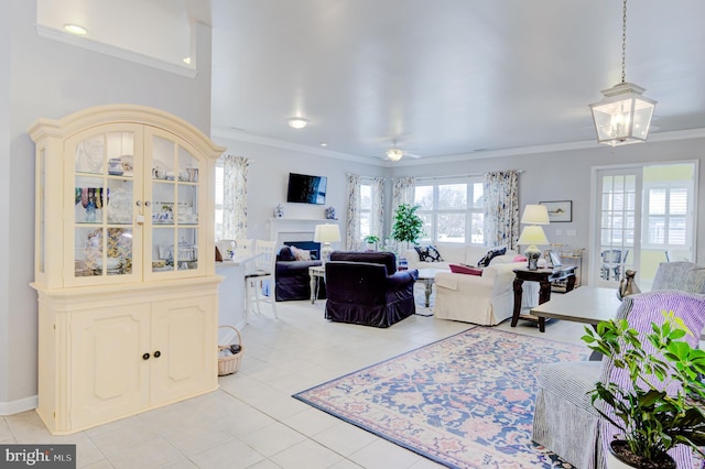 living room with light tile patterned flooring, ceiling fan, and crown molding