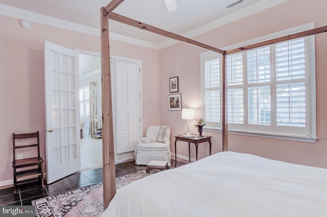 bedroom with ceiling fan, multiple windows, dark tile patterned floors, and crown molding