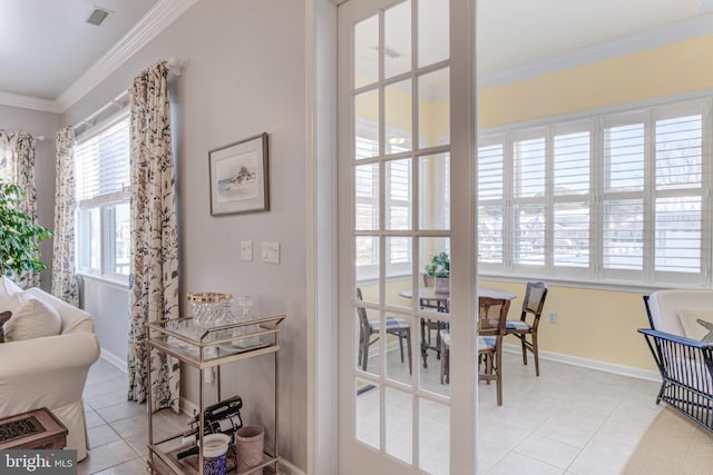 tiled dining area featuring crown molding