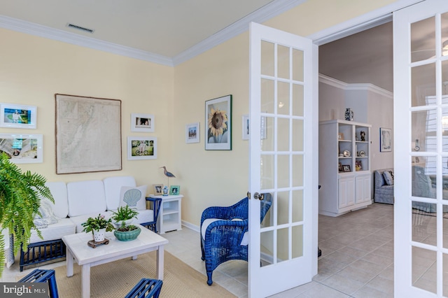 sitting room with french doors, light tile patterned floors, and crown molding