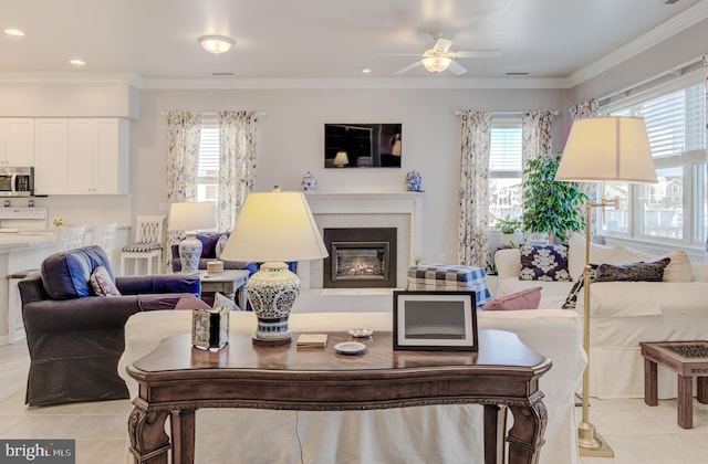 tiled living room featuring ceiling fan and crown molding