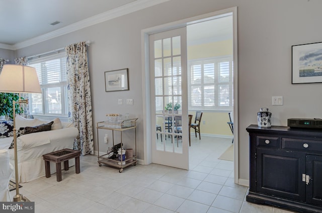 interior space featuring french doors, ornamental molding, and light tile patterned floors