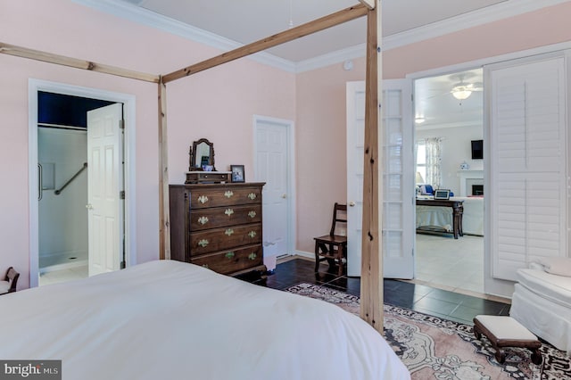 tiled bedroom featuring ensuite bathroom and crown molding