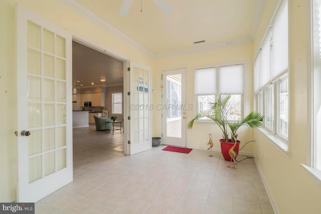 sunroom featuring french doors and ceiling fan