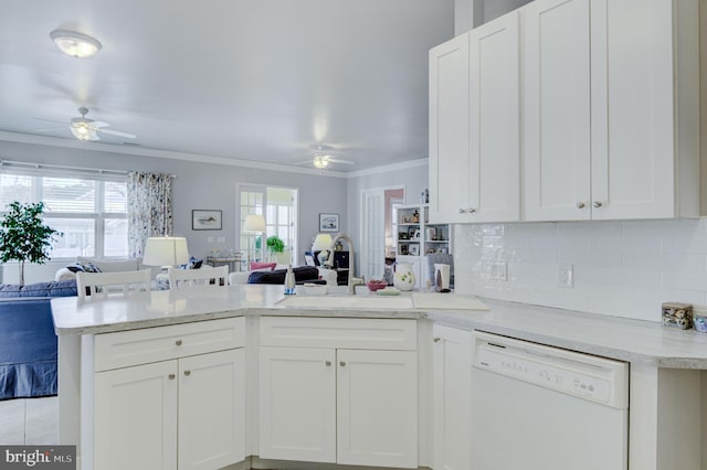 kitchen featuring kitchen peninsula, backsplash, white cabinetry, white dishwasher, and ornamental molding