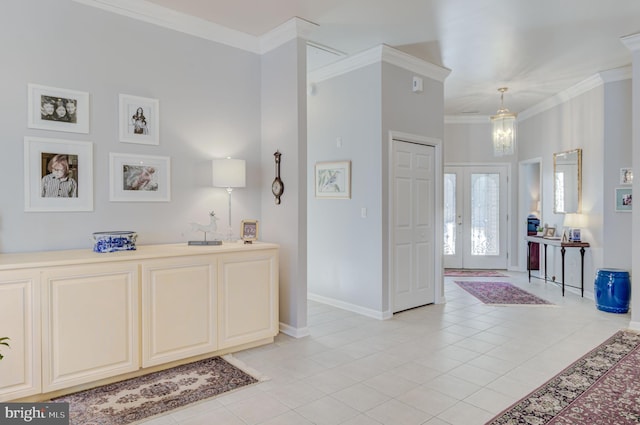 tiled foyer with french doors, an inviting chandelier, and ornamental molding