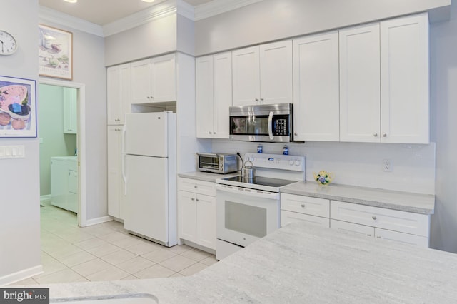 kitchen with white appliances, light tile patterned floors, decorative backsplash, white cabinets, and ornamental molding