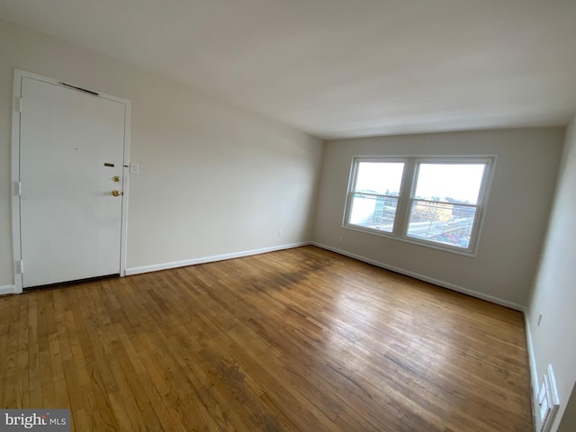 unfurnished room featuring wood-type flooring