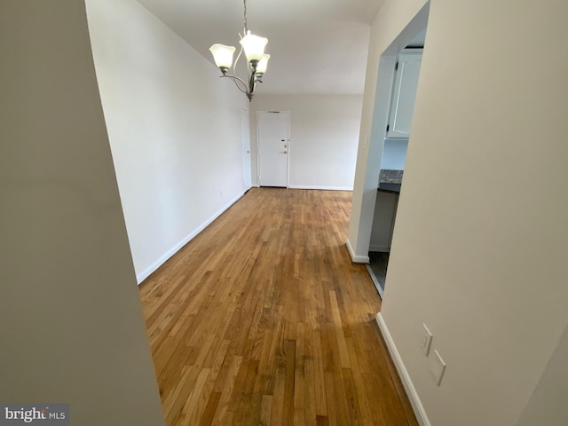 hall featuring a chandelier and light wood-type flooring