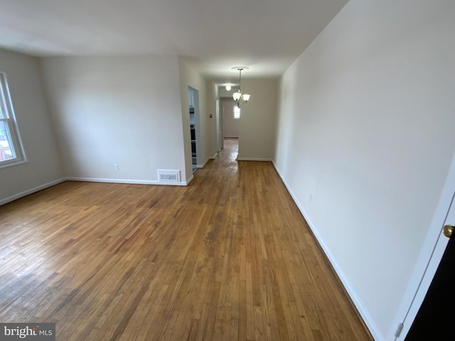 interior space with a chandelier and hardwood / wood-style floors