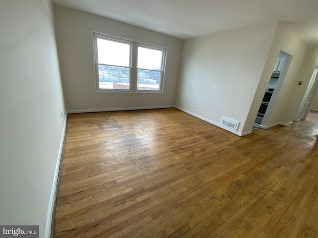 spare room with hardwood / wood-style floors