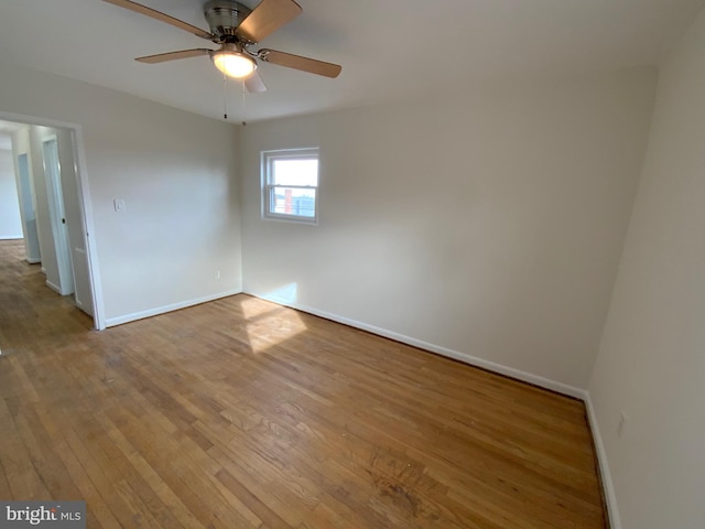 unfurnished room featuring light wood-type flooring and ceiling fan