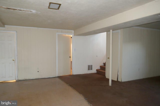 basement featuring wooden walls