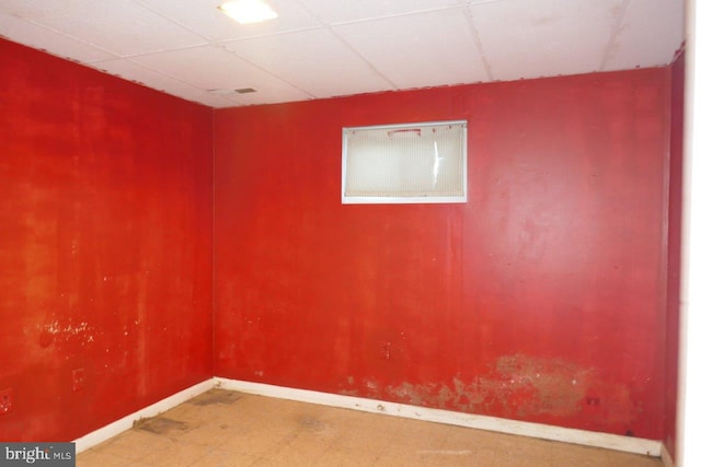 unfurnished room featuring a paneled ceiling