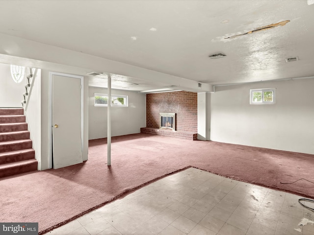 7107 Dower House Rd, Upper Marlboro, MD 20772 - basement with tile patterned floors, carpet, a brick fireplace, and stairway