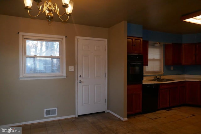 kitchen with black appliances, sink, and a chandelier