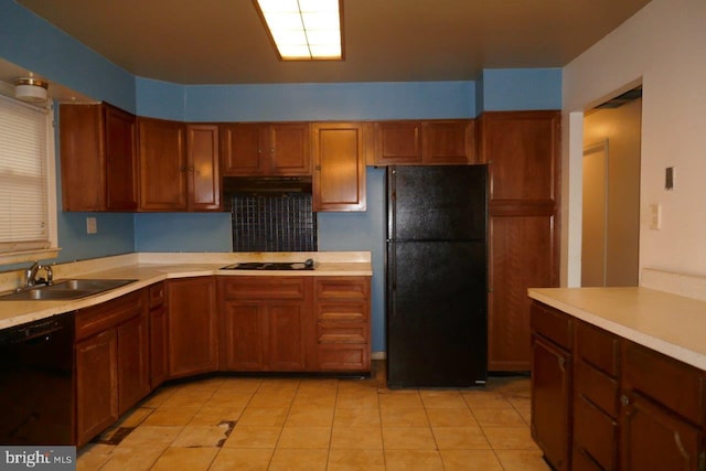 kitchen featuring sink, light tile patterned flooring, and black appliances