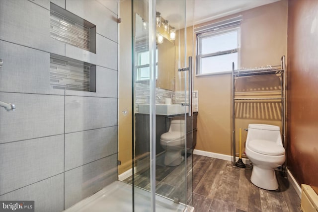 bathroom with toilet and a shower with shower door