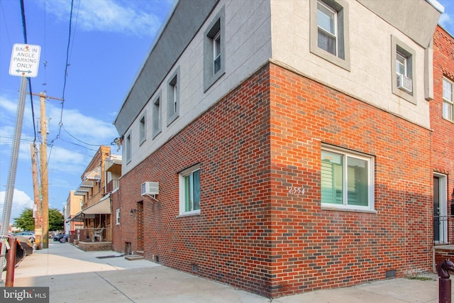 view of building exterior with an AC wall unit