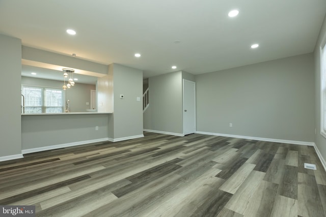 unfurnished living room featuring dark wood-type flooring