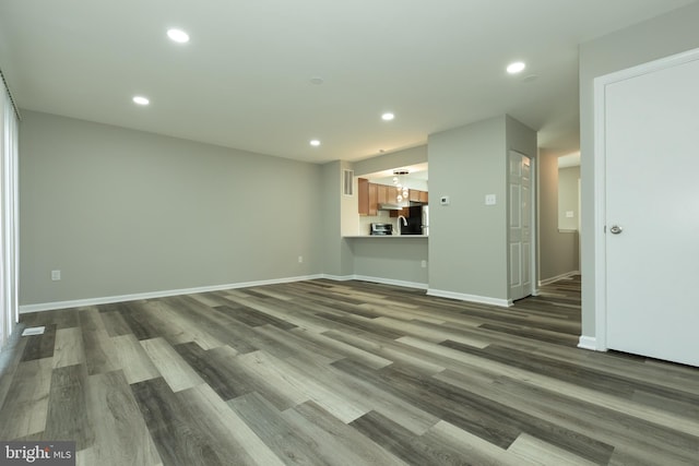 unfurnished living room featuring hardwood / wood-style flooring