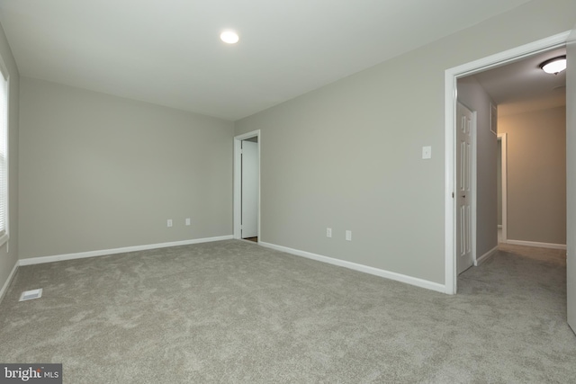 unfurnished room with light carpet