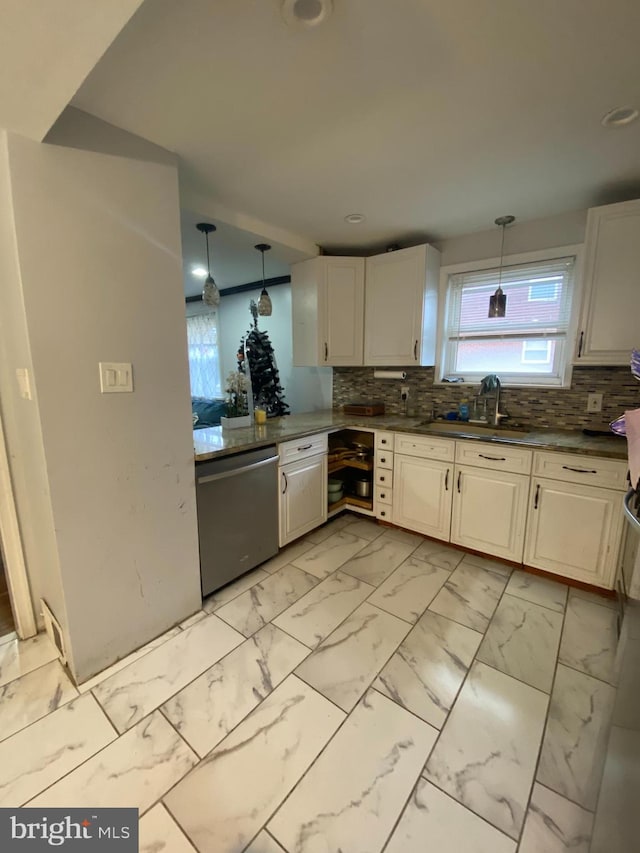 kitchen with white cabinetry, sink, stainless steel dishwasher, backsplash, and decorative light fixtures