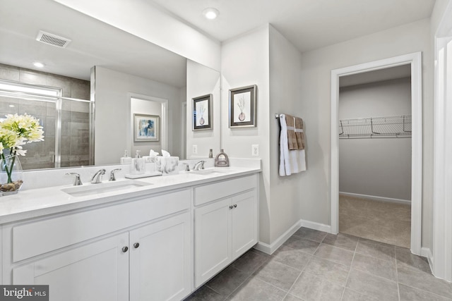 bathroom featuring vanity, tile patterned floors, and an enclosed shower