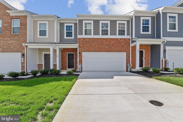 multi unit property featuring a garage and a front lawn