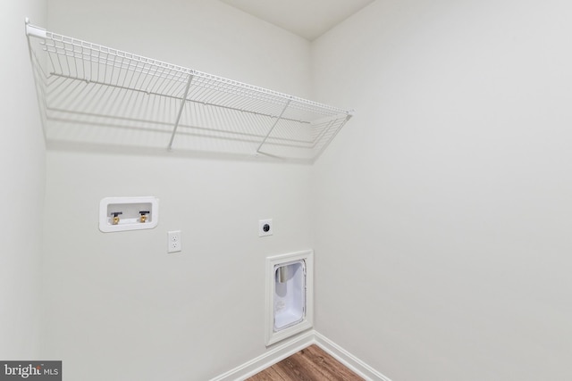 washroom with hookup for an electric dryer, washer hookup, and hardwood / wood-style flooring