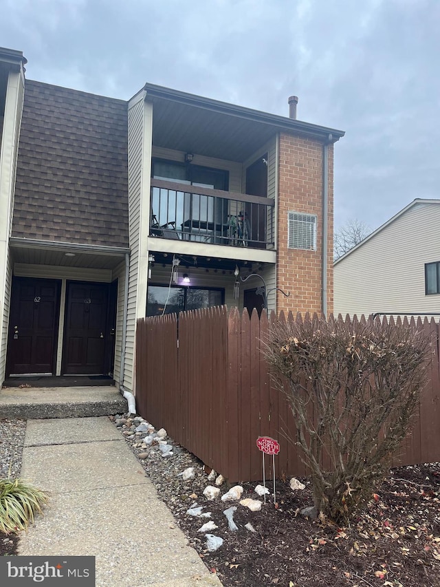 view of side of property featuring a balcony