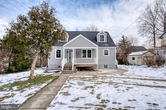 view of front of house with a storage unit and covered porch