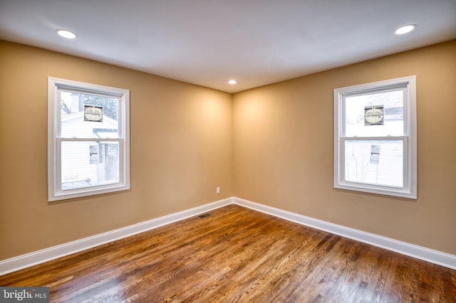 spare room with hardwood / wood-style flooring