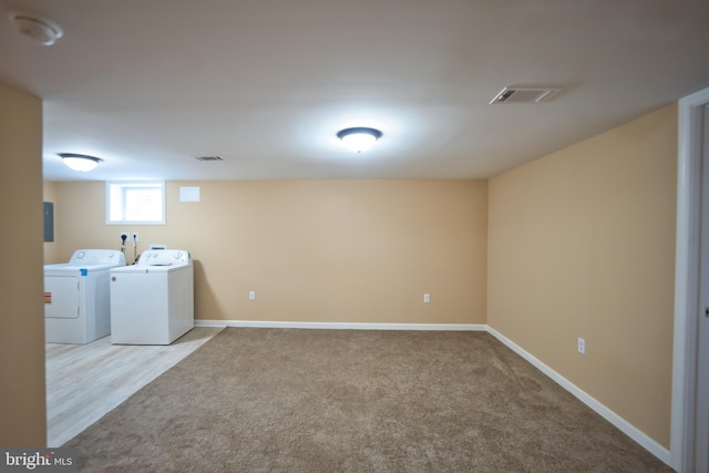 laundry room featuring light colored carpet and independent washer and dryer