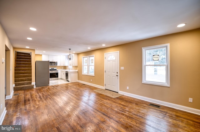 unfurnished living room with wood-type flooring