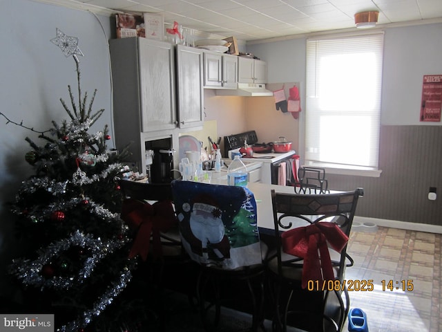 kitchen featuring extractor fan, white cabinetry, white range with electric stovetop, and crown molding