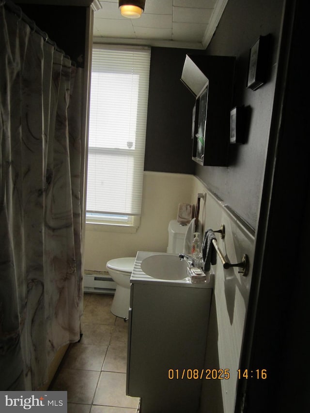 bathroom with vanity, a baseboard heating unit, tile patterned floors, crown molding, and toilet