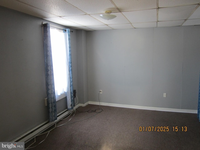 spare room with a paneled ceiling and carpet floors