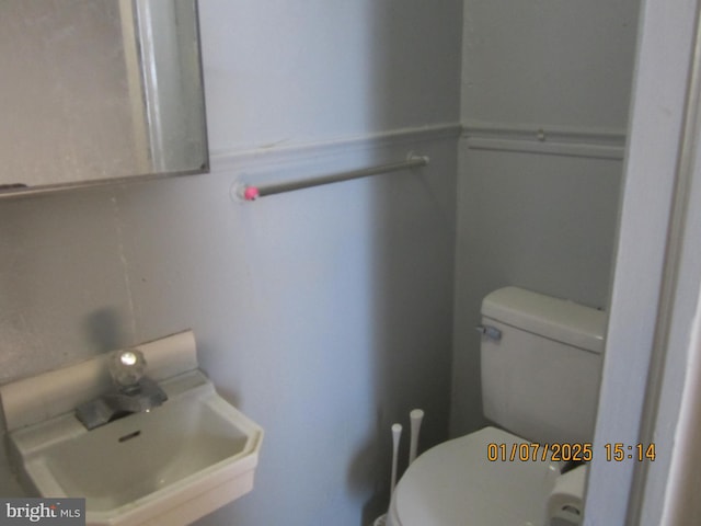 bathroom with toilet and sink