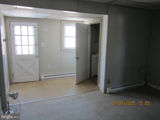 doorway to outside featuring a wealth of natural light and baseboard heating