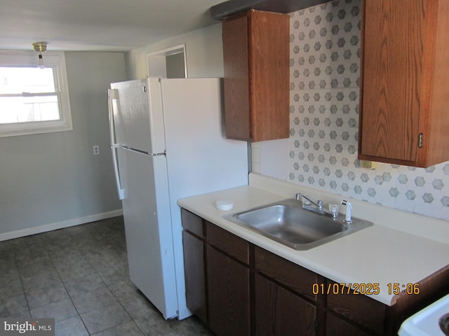 kitchen with sink and white fridge