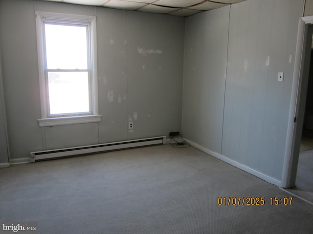 carpeted spare room with baseboard heating