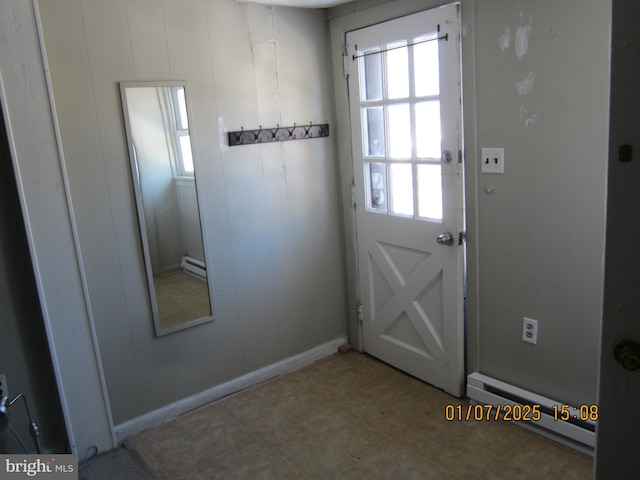 doorway to outside featuring baseboard heating