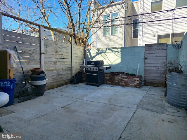 view of patio with grilling area and a fenced backyard