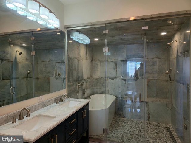 bathroom with double vanity, a shower stall, a freestanding bath, and a sink