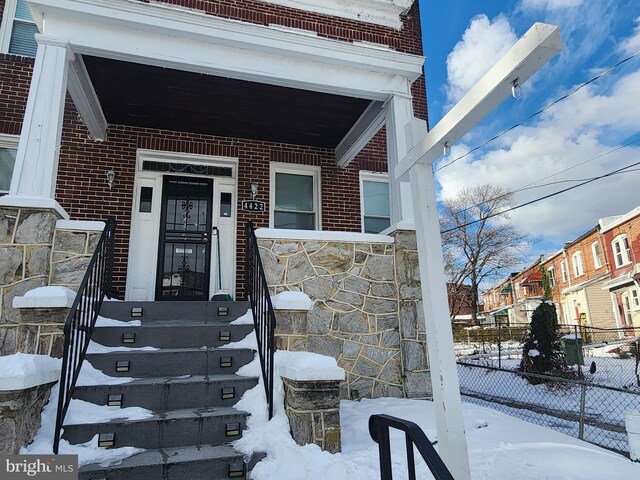 view of snow covered property entrance