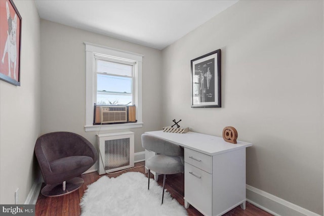 office area with radiator heating unit, hardwood / wood-style flooring, and cooling unit