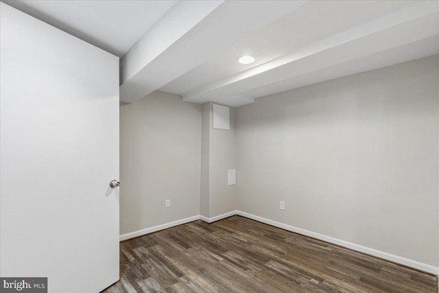 basement with dark hardwood / wood-style flooring