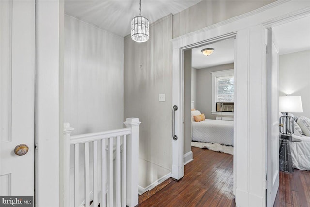 hallway featuring cooling unit, dark hardwood / wood-style floors, and an inviting chandelier