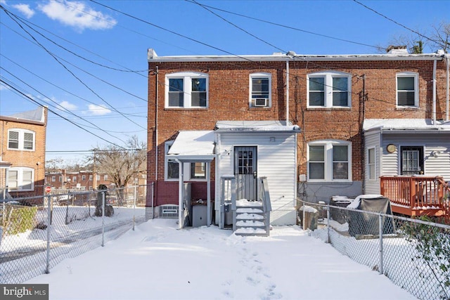 view of snow covered rear of property